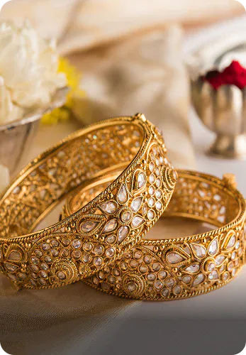 Two intricate gold bangles with diamonds, a luxury jewellery set by OM Gold & Diamonds that can serve as birthday gifts for your special someone.