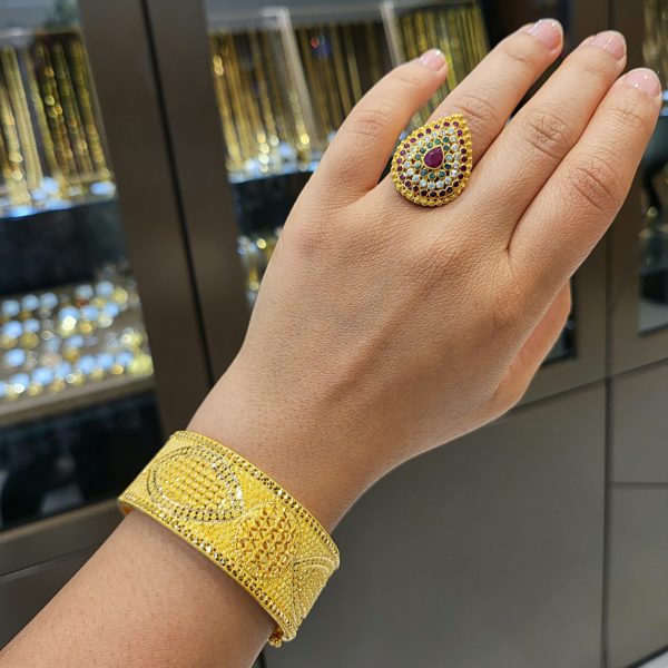 Gold Bangle and Ring on model's hand