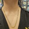 Woman wearing flat gold chain